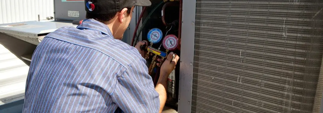 HVAC technician servicing a condenser unit in Maurice River