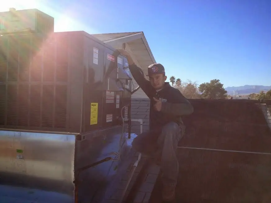 HVAC technician performing HVAC Inspection on a rooftop unit in Maurice River